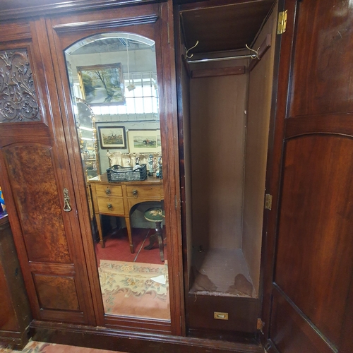 157 - A good Walnut and Burr Walnut three door Wardrobe with central bevelled mirror glass door flanked by... 