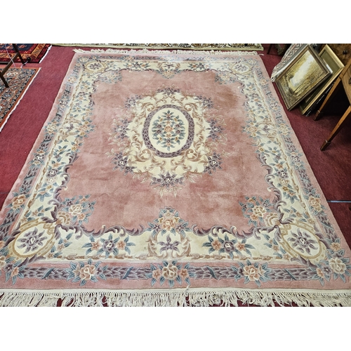 158 - A Pink ground Carpet with central medallion design and floral borders. 300 x 254 cm approx.