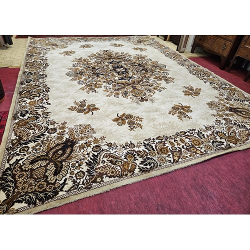 179 - A large Beige ground Carpet with large central medallion design and floral borders. 390 x 302 cm app... 