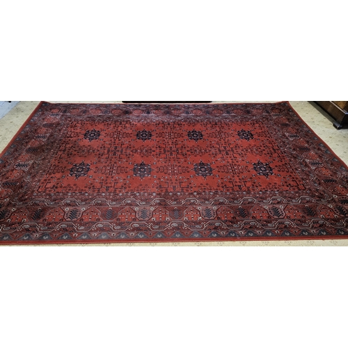 188 - A large Red ground Carpet with repeating central medallion design and multi borders. 349 x 242 cm ap... 