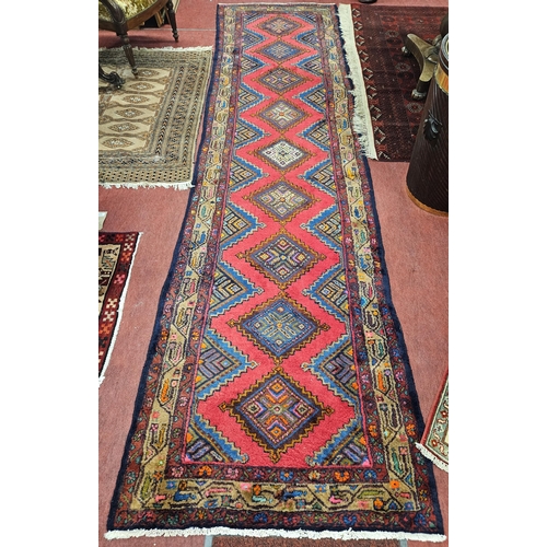 258 - A good Red ground hand woven Persian Muani Runner with repeating single central medallion design. 36... 