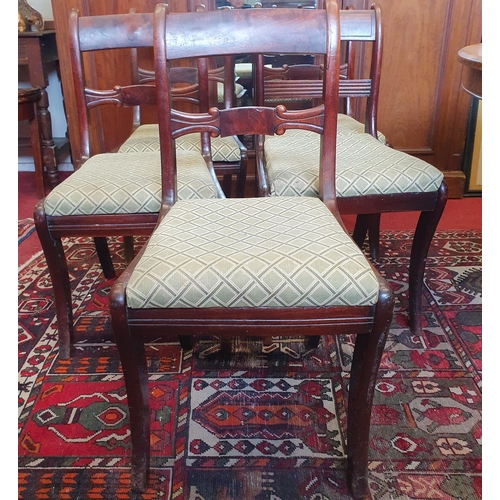 723 - A set of six early 19th Century Mahogany dining Chairs with sabre leg front and carved centre back. ... 