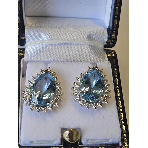 633 - A pair of 9ct Gold, Diamond and Blue Topaz Earrings.