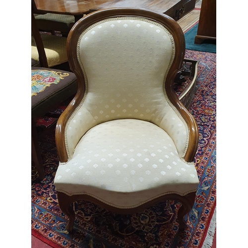 73 - A 19th Century Mahogany showframe Salon Chair with cream upholstery on carved cabriole front support... 