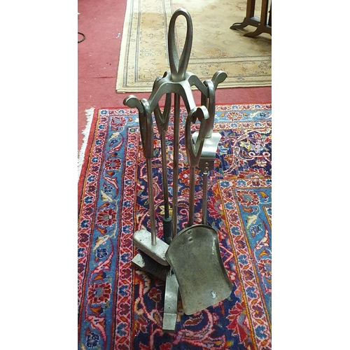 87 - A 19th Century Brass Coal Helmet along with a modern companion set.