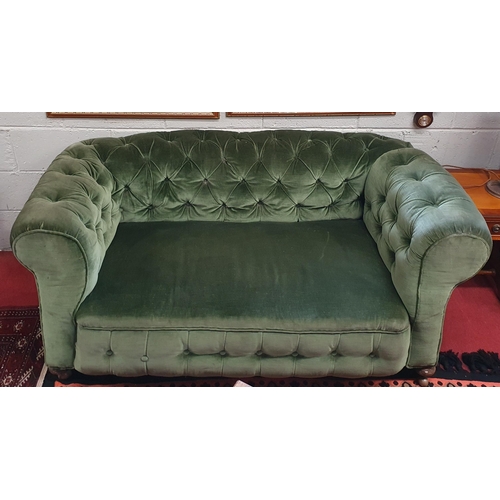 99 - A good 19th Century deep buttoned Chesterfield two seater settee with drop arm on turned supports. W... 