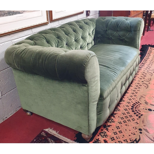 99 - A good 19th Century deep buttoned Chesterfield two seater settee with drop arm on turned supports. W... 