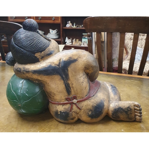 49 - A good Timber Buddha. H 36 x L 51 cm approx.