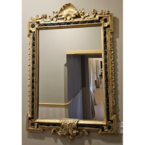 126 - A reproduction Timber and Plaster gilt Mirror with highly carved outline and shell cartouche top. W ... 