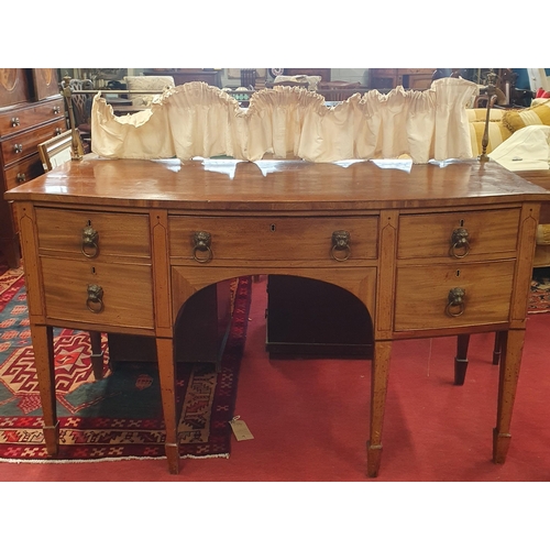 143 - A 19th Century Mahogany bow fronted Sideboard with lions head ring handles square tapered supports a... 