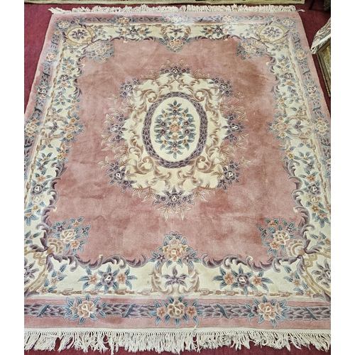 158 - A Pink ground Carpet with central medallion design and floral borders. 300 x 254 cm approx.