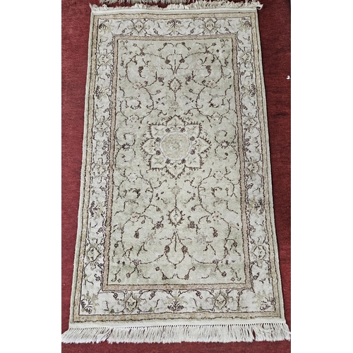 164 - A green ground Rug with multi borders and unique medallion design. 160 x 89 cm approx.