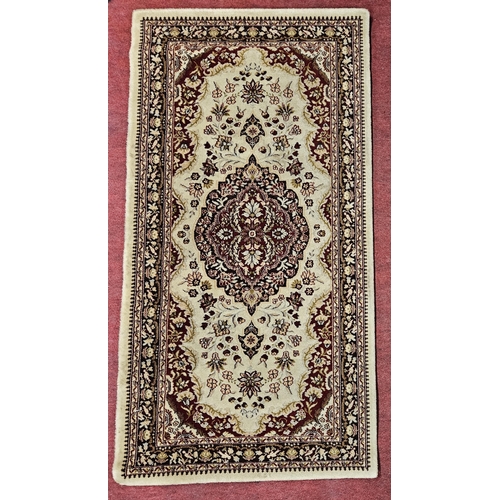 165 - A cream/beige ground Rug with multi borders and unique medallion design. 130 x 67 cm approx.