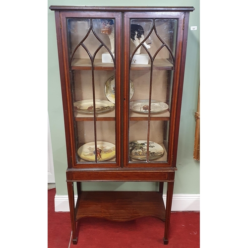 172 - An Edwardian Mahogany and inlaid miniature Display Cabinet on stand with astragal glaze doors. 68 x ... 