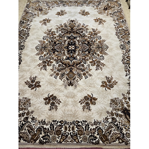 179 - A large Beige ground Carpet with large central medallion design and floral borders. 390 x 302 cm app... 