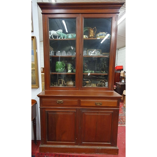 202 - A late 19th Century Walnut two door Bookcase with panel doors to the base and single panel glazed up... 