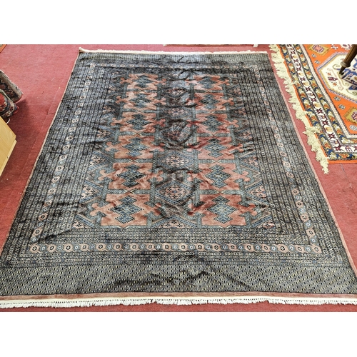 244 - A Pink ground Carpet with repeating central medallion design and multi borders. 304 x 250 cm approx.