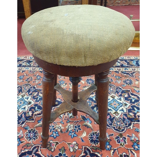 253 - A Georgian Mahogany rise and fall revolving Stool on turned supports and stretcher base. D 33 cm app... 