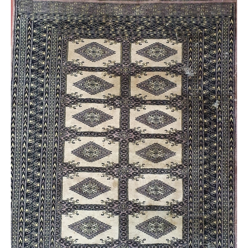 655 - A Persian Brown Rug with repeating medallion design. 200 x 129 cm approx. Worn in patches.