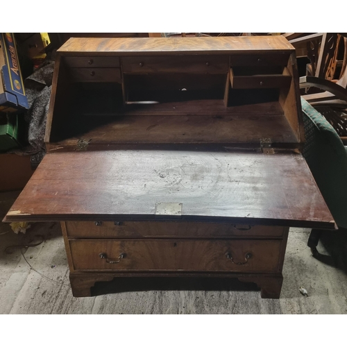 842 - A 19th Century Mahogany Bureau with flame grain fall flap and a fitted interior.