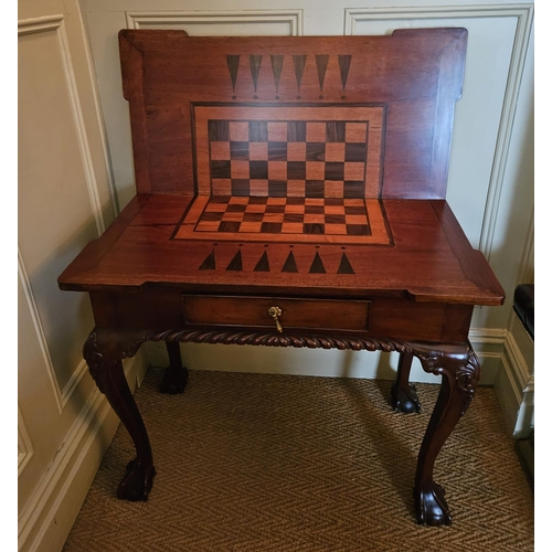 851 - A reproduction Mahogany foldover Games Table with single frieze drawer on carved cabriole ball and c... 