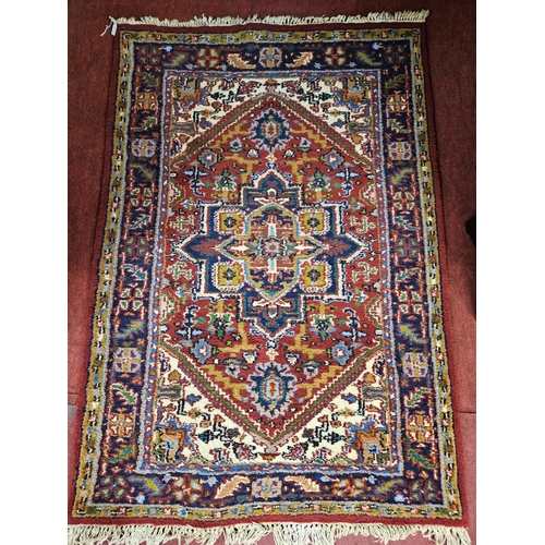 6 - A good Persian red ground Rug with large central geometric medallions, on a densely populated centra... 