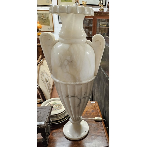 656 - An extremely large Alabaster urn shaped table Lamp with fitted light. H 78 cm approx.