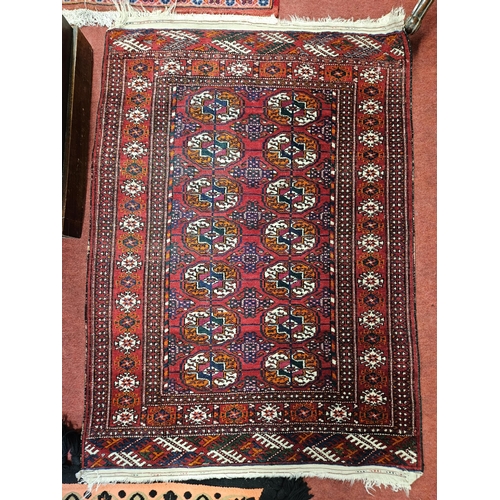 96 - A red ground Rug with repeating central medallion design and multi borders. Mehdi 125 x 87 cm approx... 