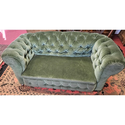 99 - A good 19th Century deep buttoned Chesterfield two seater settee with drop arm on turned supports. W... 