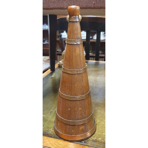 663 - An Obelisk style Oak copper bound Decanter.
H 36 cm approx.