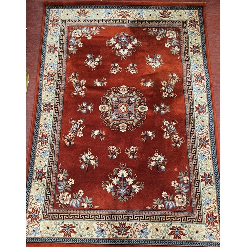 708 - A Red ground Carpet with central medallion design, multi borders and Greek key design.
L 231 x W 171... 