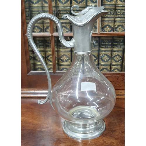 779 - A lovely early 20th Century Glass Ewer with Pewter handle. H 26 cm approx.