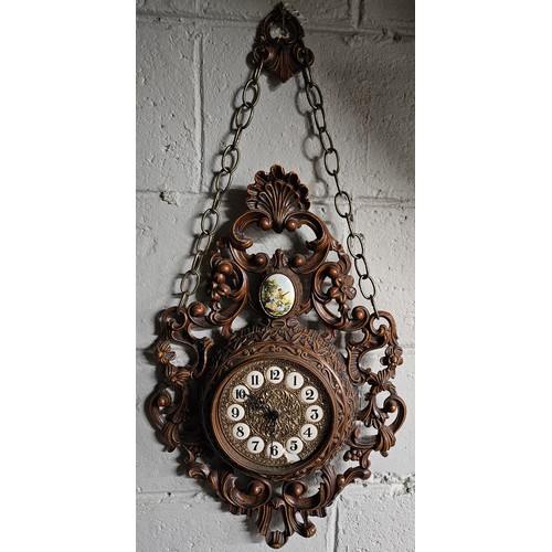 814 - A decorative wall Clock with a pierced outline and a quartz movement. H 77 x W 36 cm approx.