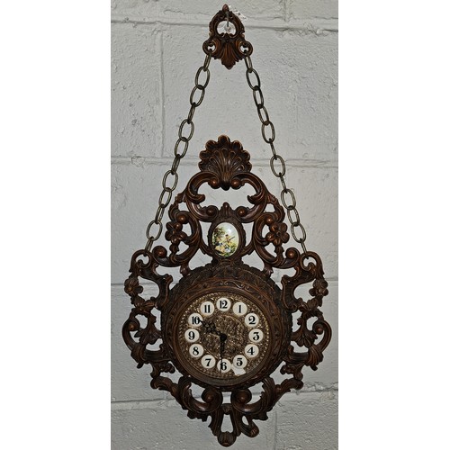 814 - A decorative wall Clock with a pierced outline and a quartz movement. H 77 x W 36 cm approx.