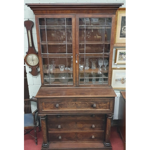 7 - A Regency Mahogany Secretaire Bookcase possibly Irish, with glazed upper section and pillared and dr... 