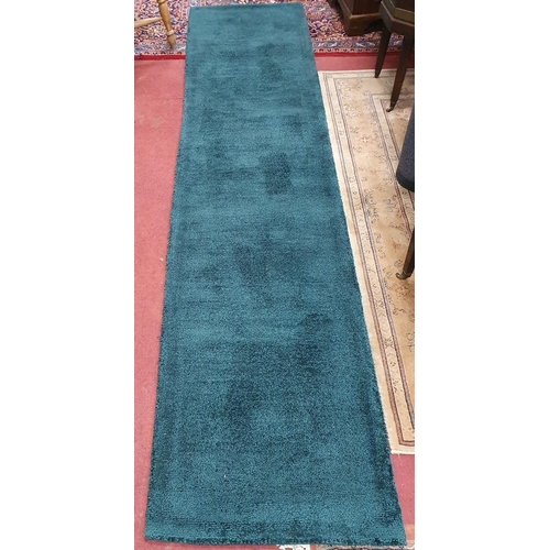 47 - A pair of modern green ground Runners. 299 x 65 cm approx.