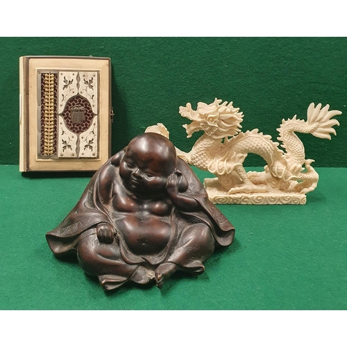 68 - A saucy Buddha Figure along with a Dragon and a Koran.