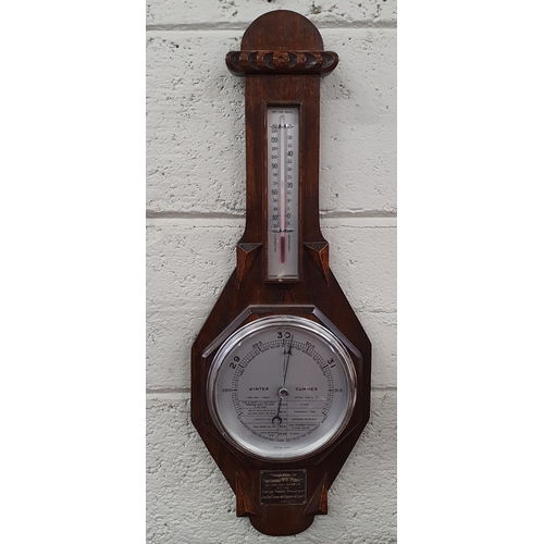 132 - An early 20th Century Oak Arts and Crafts aneroid Barometer. H 65 cm approx.