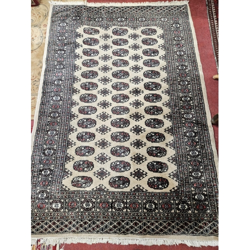 232 - A  cream ground Rug with repeating central medallion design and multi borders.
 L 190 x 126 cm appro... 