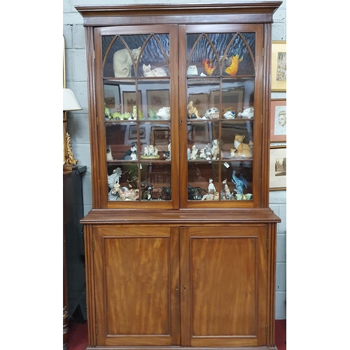 251 - Of Fantastic quality. An early 19th Century Mahogany two door Bookcase with reeded column supports a... 