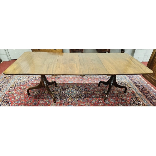 303 - An early 19th Century two Pillar Dining Table on tripod supports with twin leaves.
H 74 x W 233 x D ... 