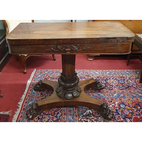 309 - An early 19th Century Rosewood and Veneered Irish Foldover Card Table on highly carved support and p... 