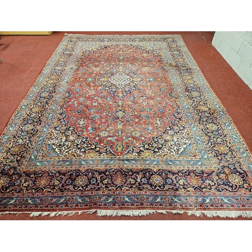 312 - A large Persian Tabriz red ground Rug with unique central medallion design and multi borders. (sligh... 