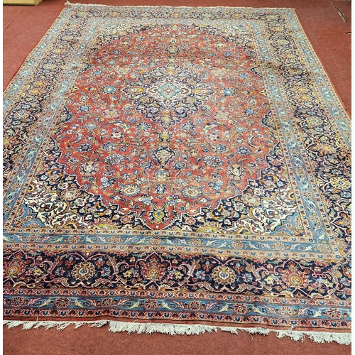 312 - A large Persian Tabriz red ground Rug with unique central medallion design and multi borders. (sligh... 