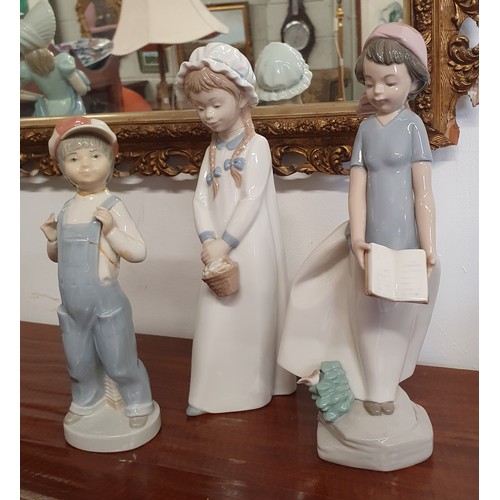 397 - Two Nao Figures of Children along with a Lladro figure of a boy. AF. Tallest H 27 cm approx.