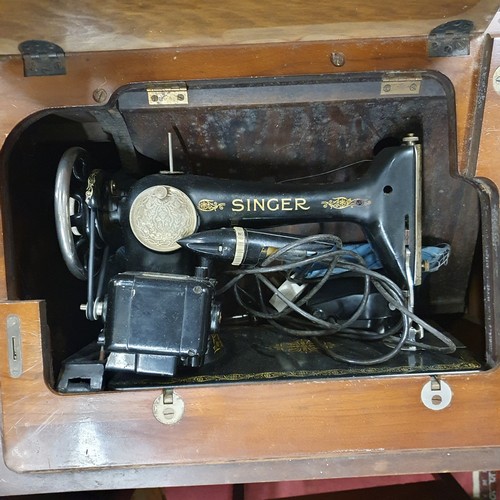 454 - A cased Singer Sewing Machine with fully fitted cabinet. 81 x 43 x H 75 cm approx.