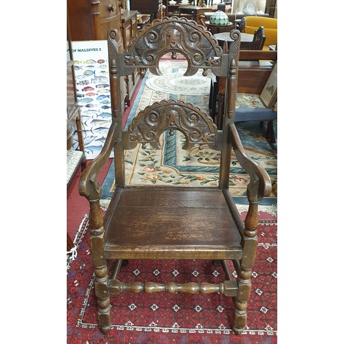 456 - An early 19th possibly 18th Century Oak Bishops Chair with highly carved back on turned supports and... 