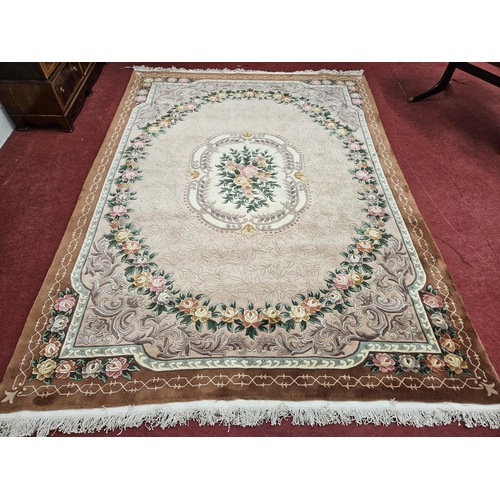 475 - An extremely large brown and cream ground Oriental Carpet with multi borders and repeating floral de... 