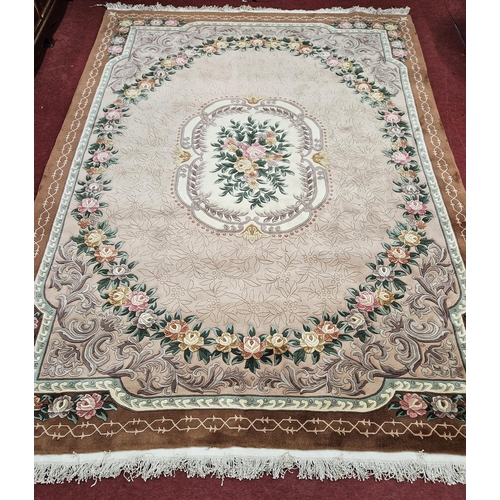 475 - An extremely large brown and cream ground Oriental Carpet with multi borders and repeating floral de... 