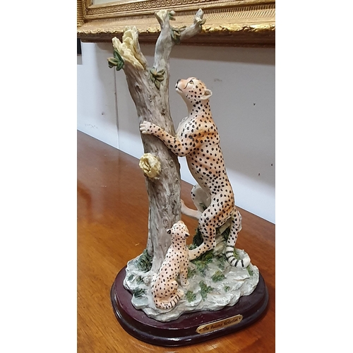 527 - A Ceramic style Figure of a leopard and cubs climbing a tree along with another. Tallest being 36 cm... 